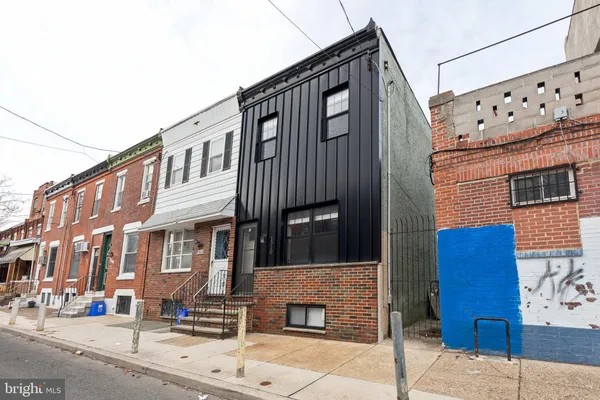 a brick building with a door and a window