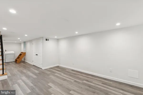 an empty room with wooden floor and a window
