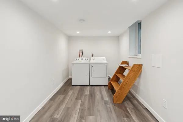 a view of a room with wooden floor and white walls