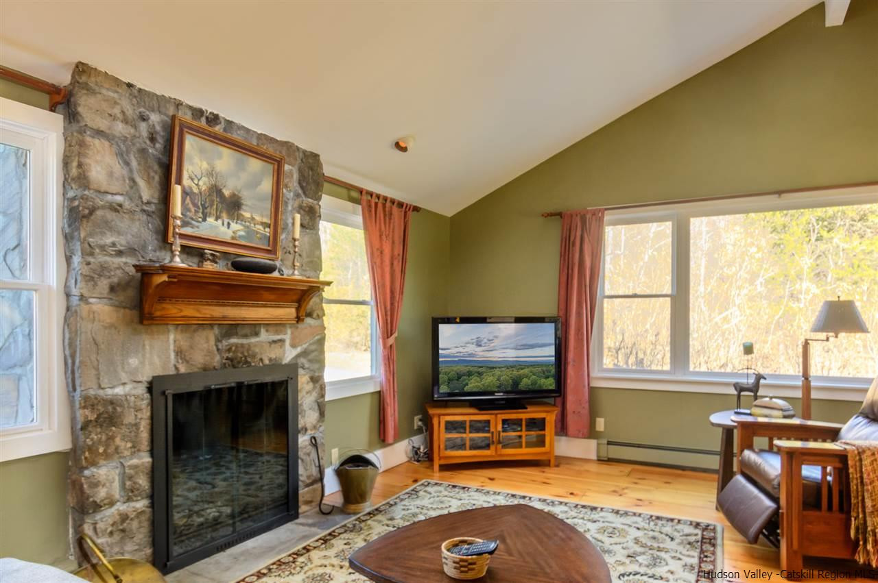 11 Sherman Road Woodstock, NY 12498 - Photo 5 of 19 a living room with furniture a flat screen tv and a fireplace