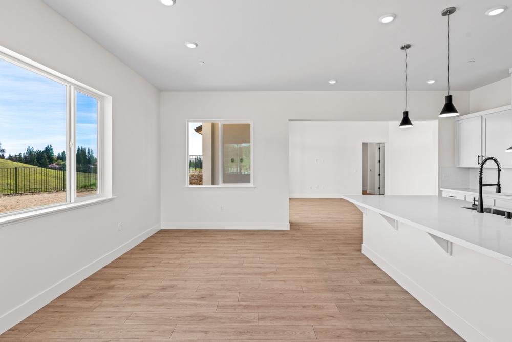 14854 Grace Warren Way Rancho Murieta, CA 95683 - Photo 12 of 27 a view of a kitchen with a sink and dishwasher with wooden floor