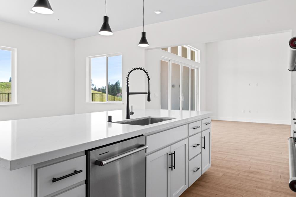 14854 Grace Warren Way Rancho Murieta, CA 95683 - Photo 15 of 27 a kitchen with sink and mirror