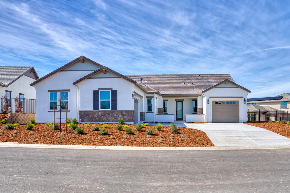 14854 Grace Warren Way Rancho Murieta, CA 95683 - Photo 2 of 27 a front view of a house with a yard
