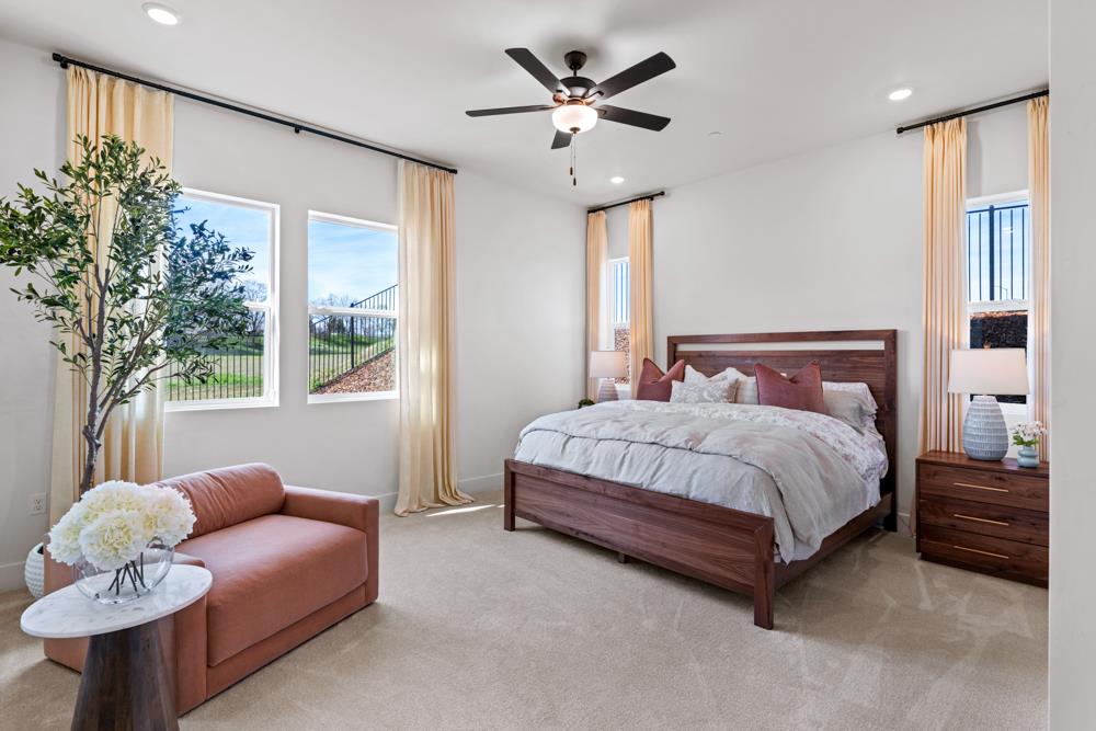 14854 Grace Warren Way Rancho Murieta, CA 95683 - Photo 23 of 27 a bedroom with a bed a couch and a chandelier