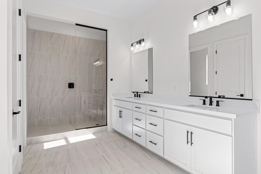 14854 Grace Warren Way Rancho Murieta, CA 95683 - Photo 25 of 27 a bathroom with double vanity sink and mirror