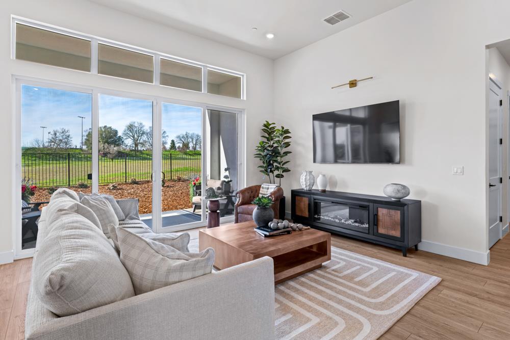 14854 Grace Warren Way Rancho Murieta, CA 95683 - Photo 5 of 27 a living room with furniture tv and a floor to ceiling window