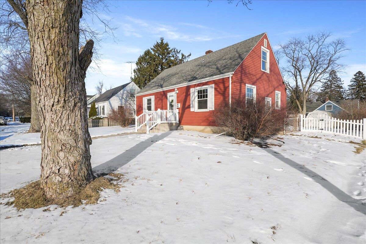 1102 Lafayette Street Valparaiso, IN 46383 - Photo 3 of 25 a front view of a house with a yard covered with snow