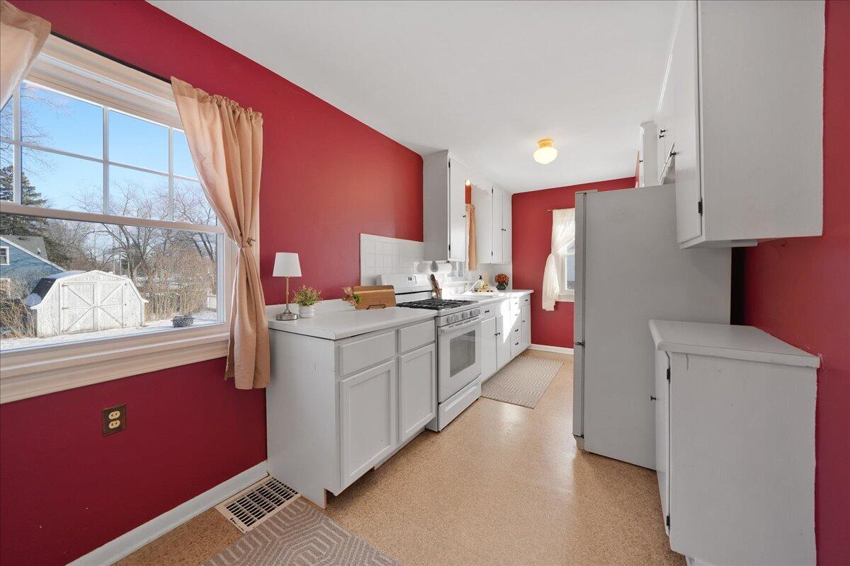 1102 Lafayette Street Valparaiso, IN 46383 - Photo 8 of 25 a kitchen with stainless steel appliances sink cabinets and wooden floor