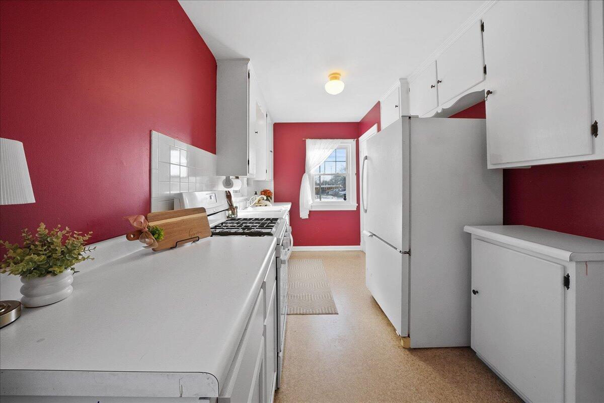 1102 Lafayette Street Valparaiso, IN 46383 - Photo 9 of 25 a kitchen with a refrigerator and a more cabinets