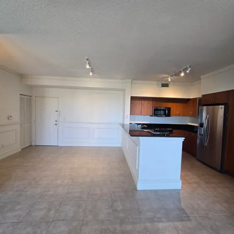 a kitchen with stainless steel appliances a refrigerator and a stove