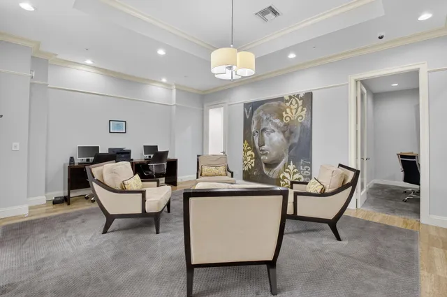 a living room with furniture a chandelier and a piano