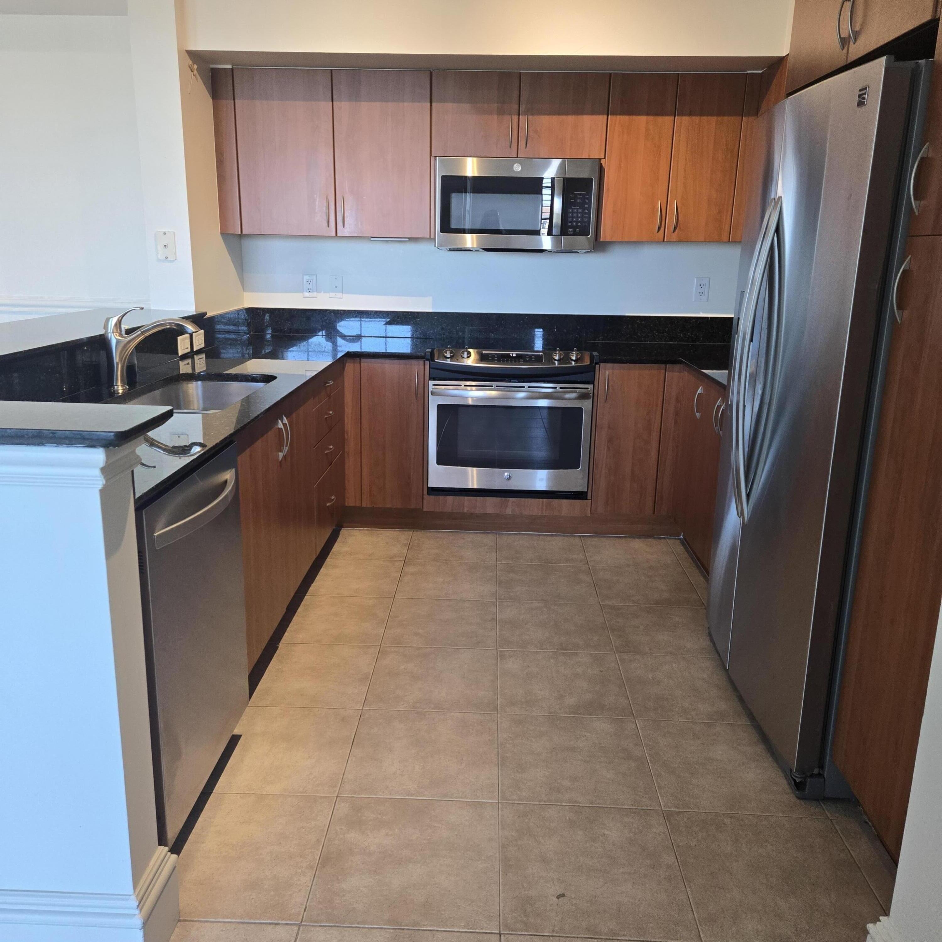 233 South Federal Highway, Unit 721 Boca Raton, FL 33432 - Photo 5 of 50 a kitchen with stainless steel appliances granite countertop a refrigerator a stove and a sink