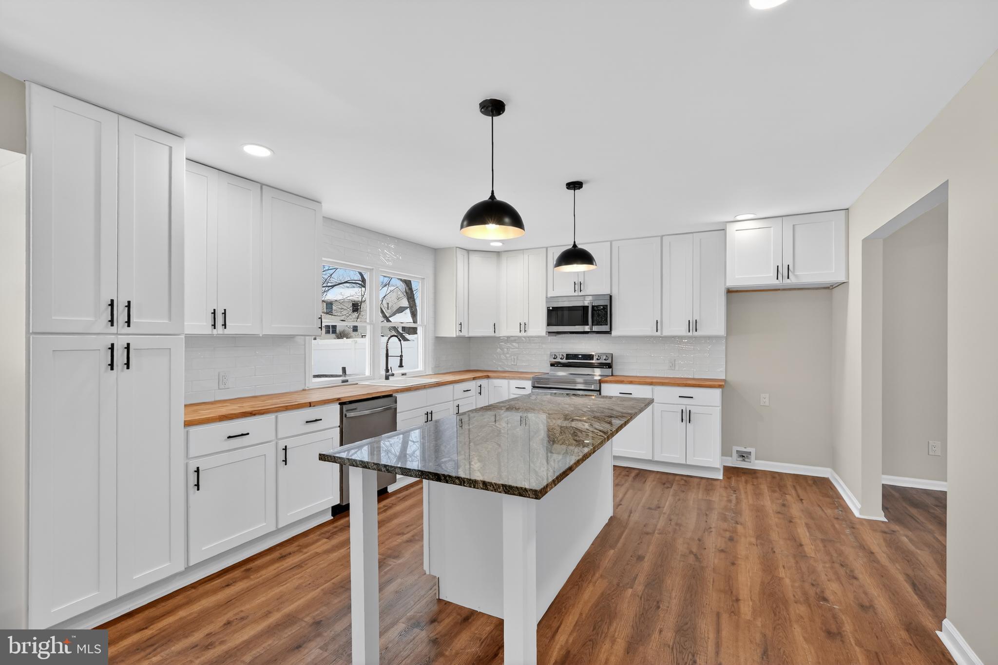 1173 Independence Way Hatfield, PA 19440 - Photo 6 of 26 a kitchen with stainless steel appliances granite countertop a sink stove and wooden floor