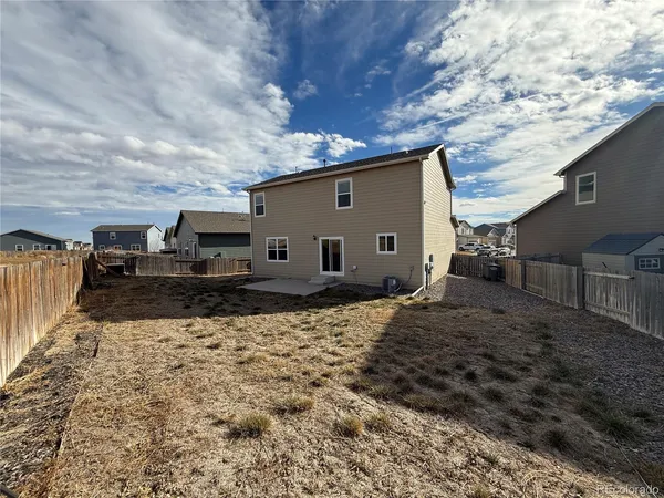 a view of a house with backyard and sitting area