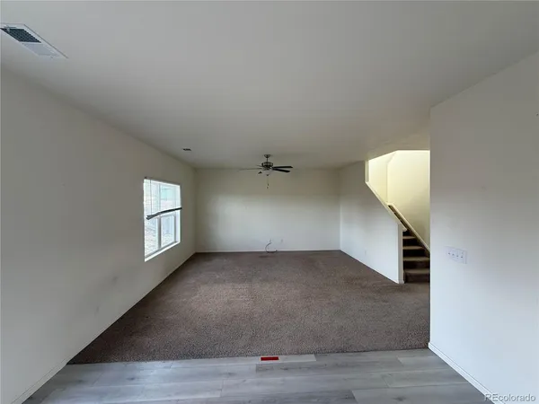an empty room with windows and closet