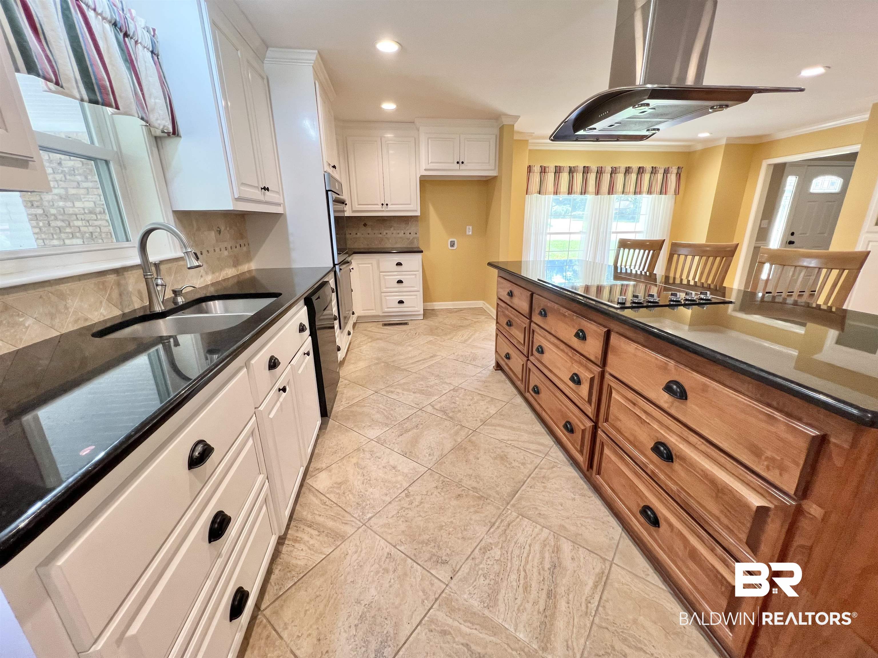2691 Appleton Road Brewton, AL 36426 - Photo 15 of 60 Kitchen featuring island exhaust hood, dark stone counters, white cabinetry, backsplash, and crown molding