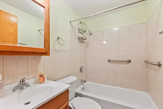 a bathroom with a sink mirror toilet and bathtub