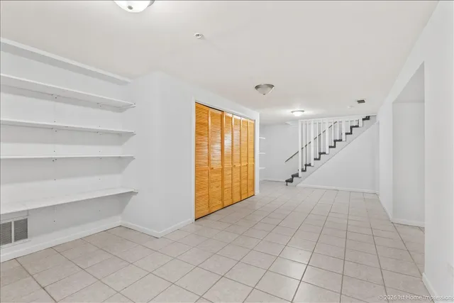 a view of an empty room with stairs