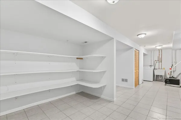 a view of walk in closet with empty racks