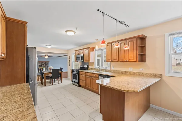 a large kitchen with kitchen island a sink stainless steel appliances and cabinets