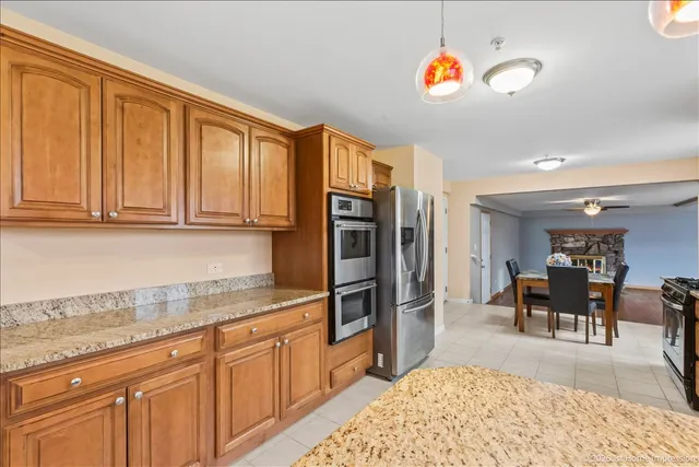 a kitchen with stainless steel appliances granite countertop a refrigerator and cabinets