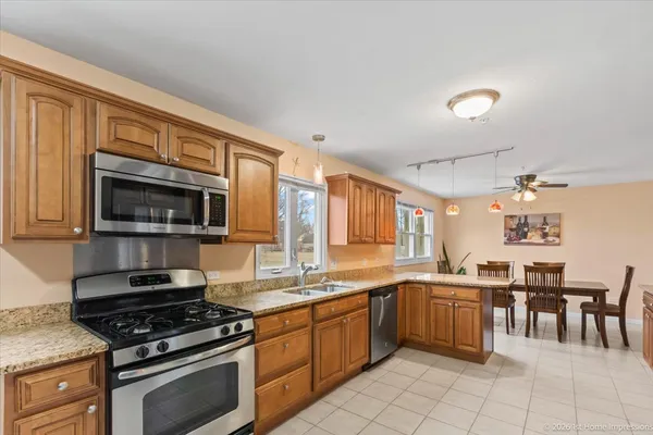 a kitchen with stainless steel appliances a stove sink microwave and cabinets