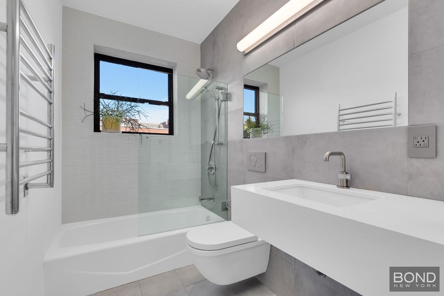 103 Remsen Avenue Brooklyn, NY 11212 - Photo 4 of 11 a bathroom with a sink toilet and bathtub