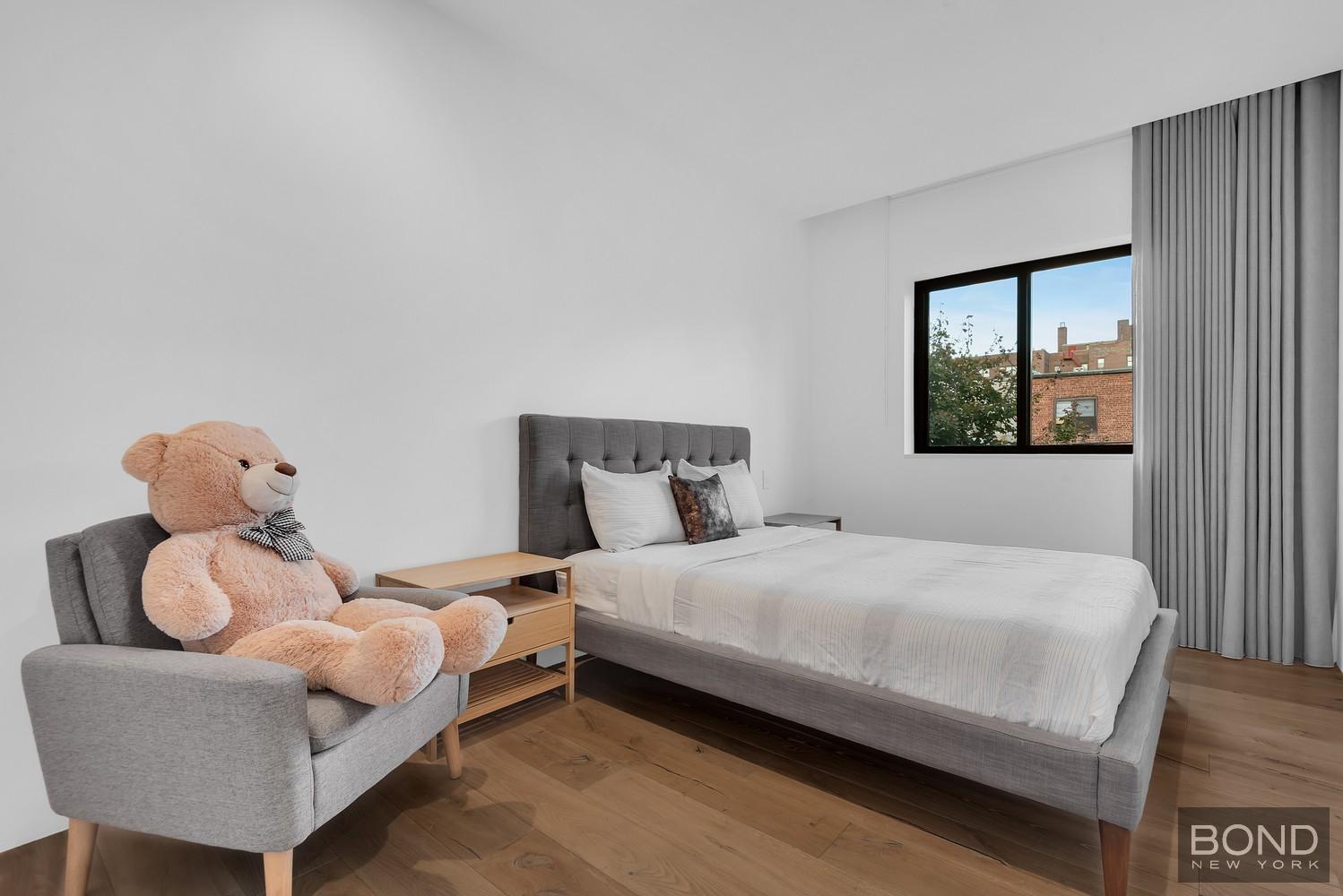 103 Remsen Avenue Brooklyn, NY 11212 - Photo 6 of 11 a bedroom with a bed and a window