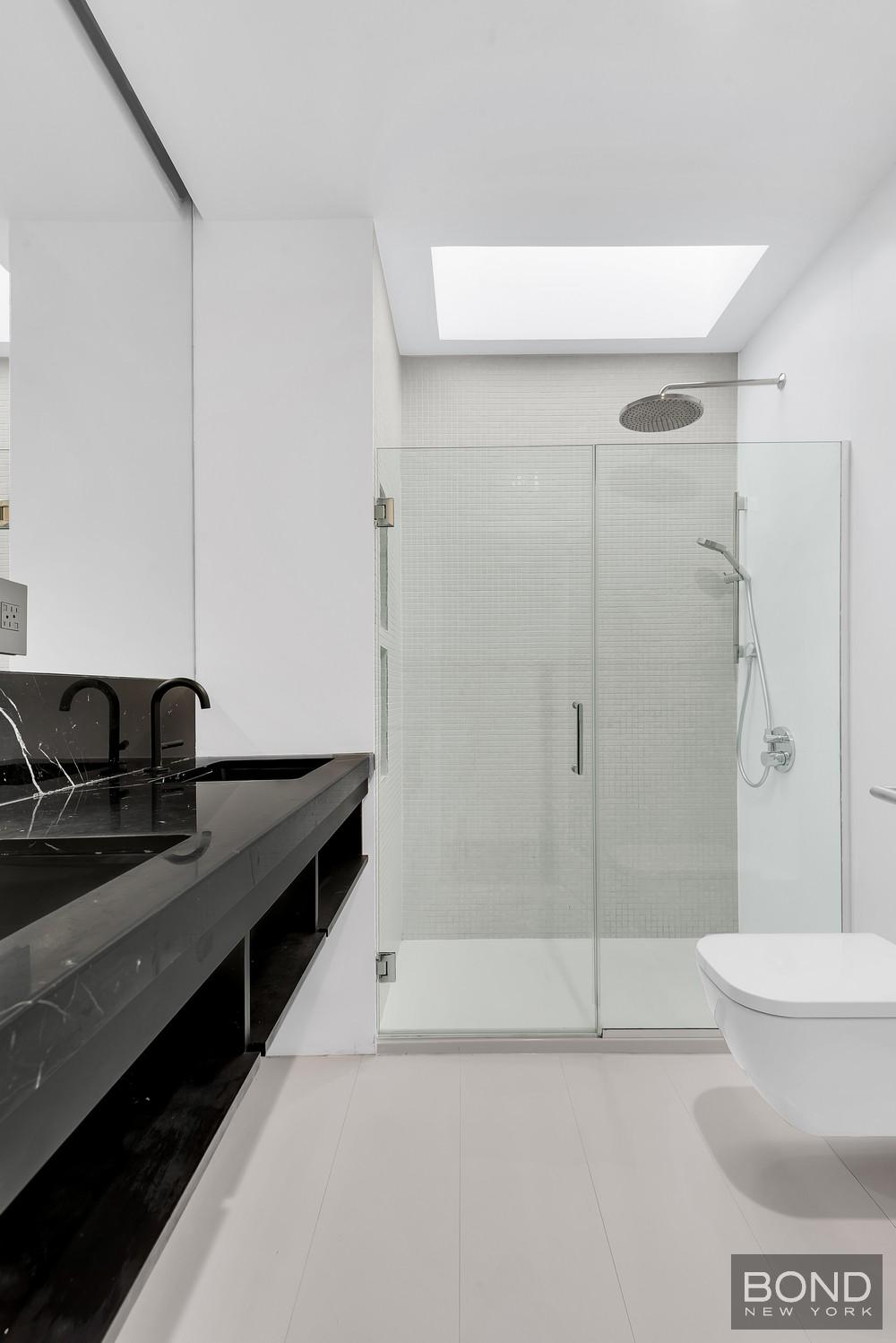 103 Remsen Avenue Brooklyn, NY 11212 - Photo 7 of 11 a bathroom with a granite countertop sink a toilet and shower