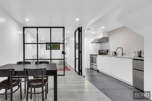 a kitchen with stainless steel appliances kitchen island granite countertop a sink and cabinets