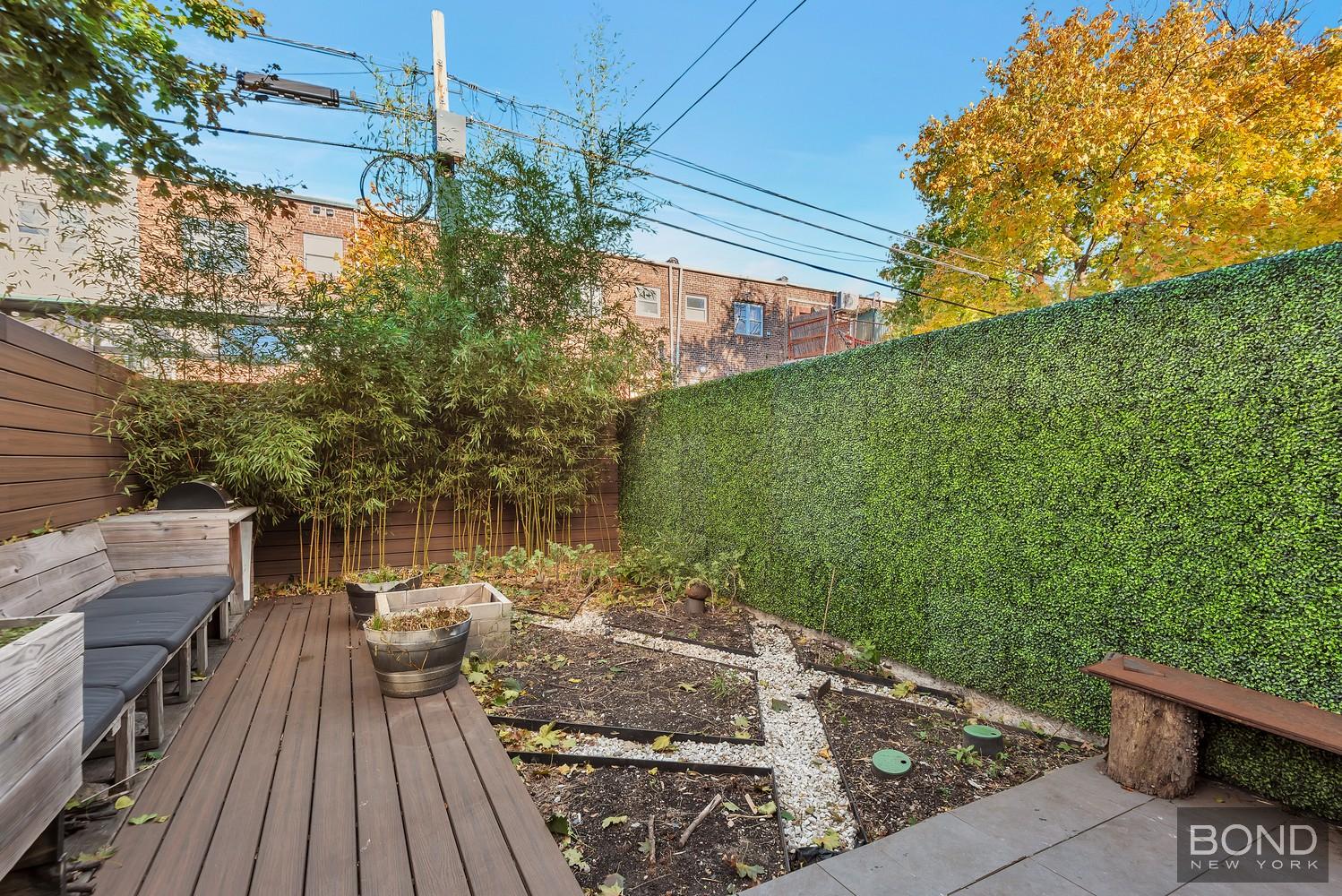 103 Remsen Avenue Brooklyn, NY 11212 - Photo 10 of 11 a view of a balcony with wooden floor and outdoor seating