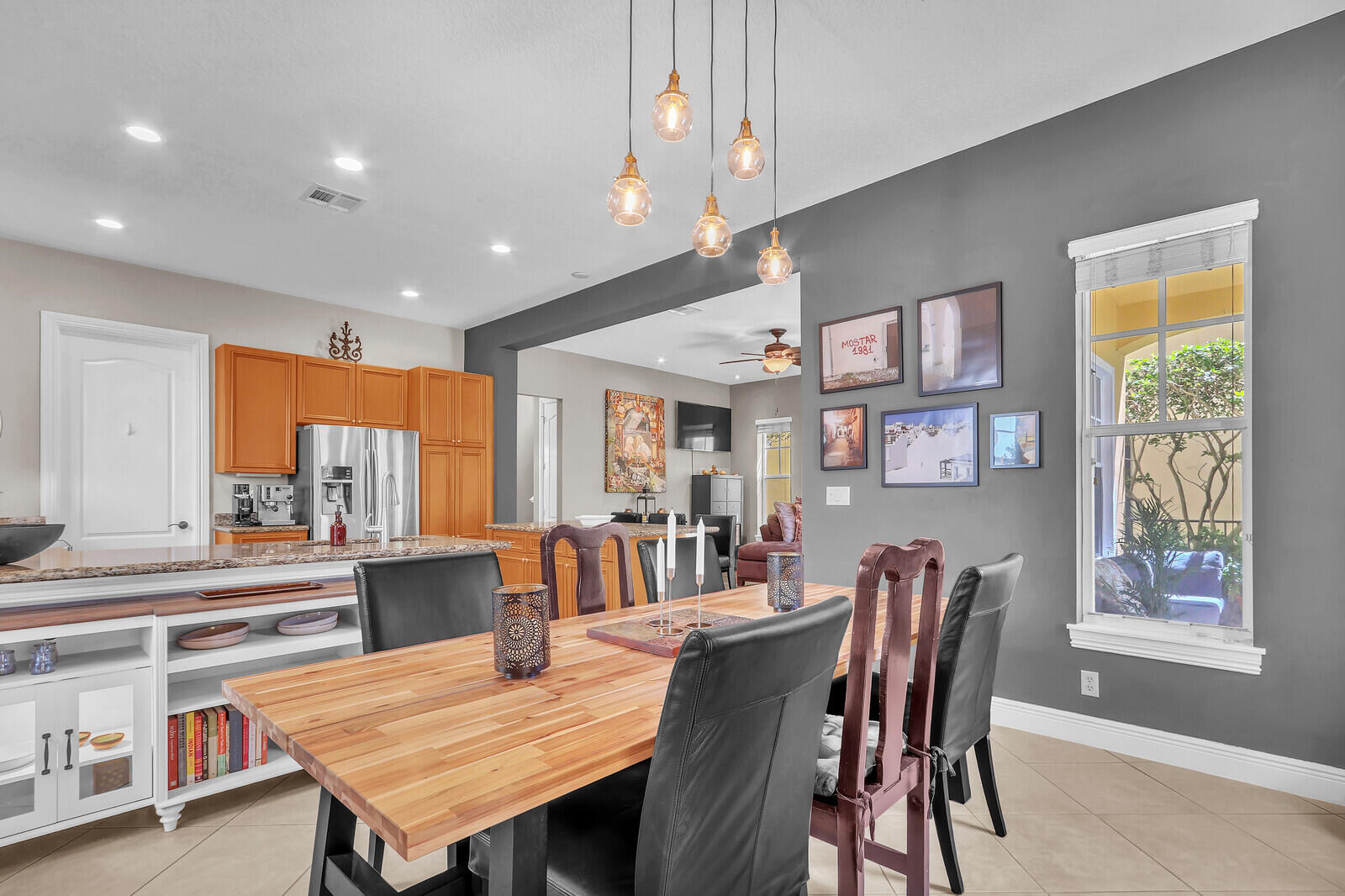 122 Inkberry Drive Jupiter, FL 33458 - Photo 16 of 56 a dining room with furniture a rug and wooden floor