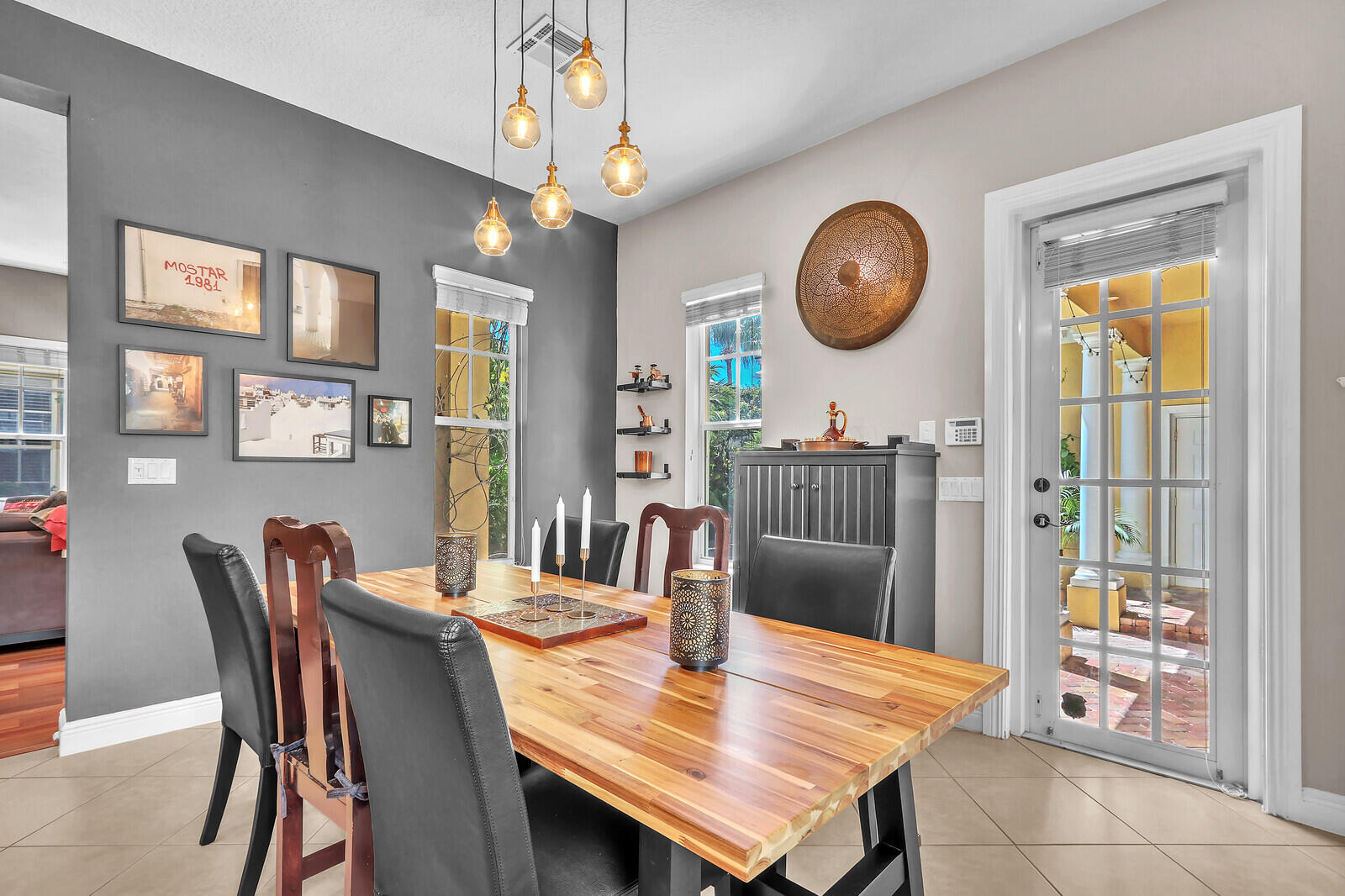 122 Inkberry Drive Jupiter, FL 33458 - Photo 17 of 56 a view of a dining room with furniture and a large window