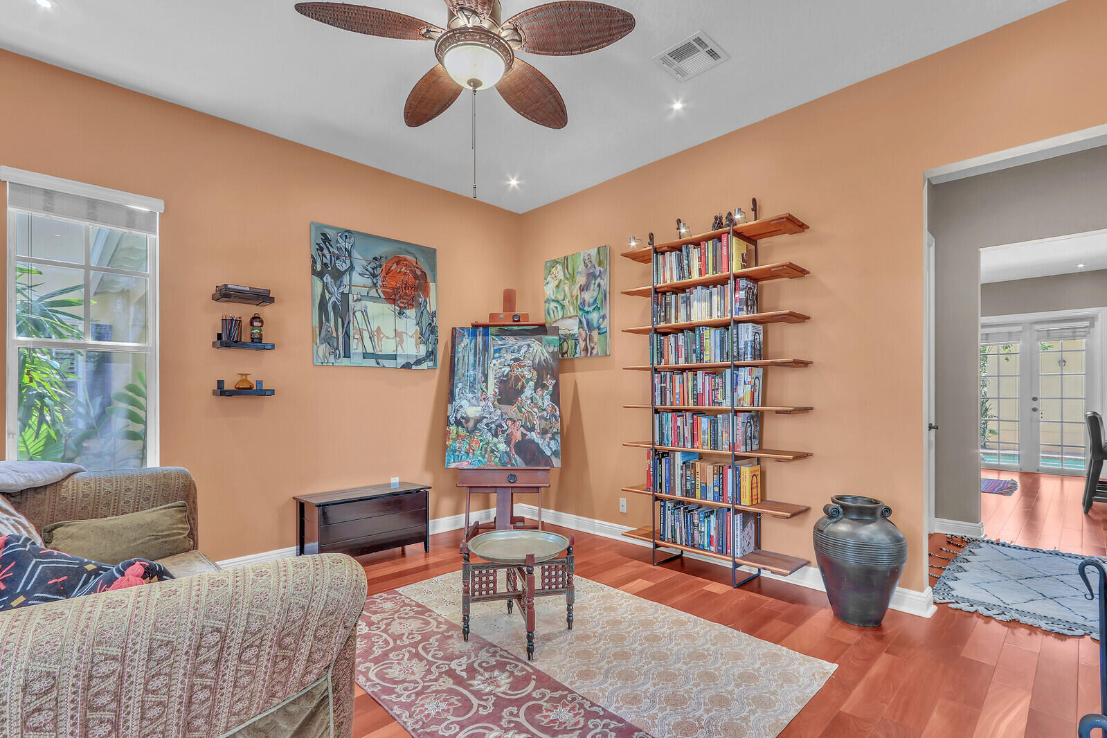 122 Inkberry Drive Jupiter, FL 33458 - Photo 20 of 56 a living room with furniture and a book shelf