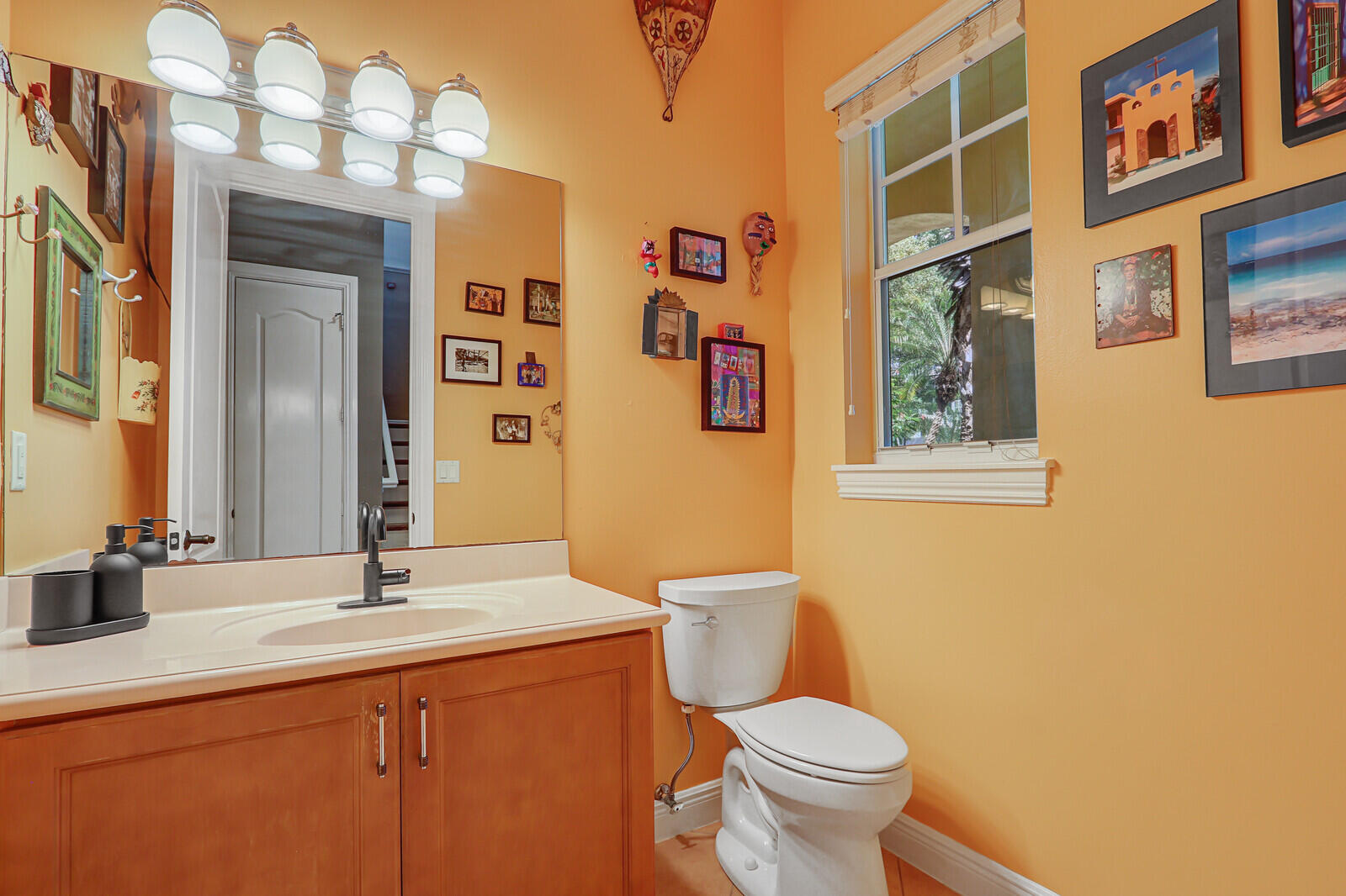122 Inkberry Drive Jupiter, FL 33458 - Photo 21 of 56 a bathroom with a toilet sink and mirror