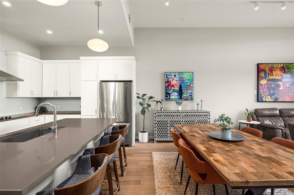 5921 Hiline Road, Unit 2404 Austin, TX 78734 - Photo 11 of 36 a kitchen with stainless steel appliances granite countertop a dining table chairs refrigerator and sink