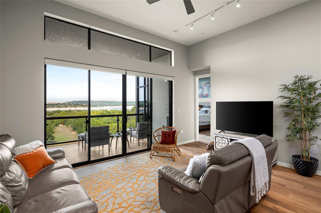 5921 Hiline Road, Unit 2404 Austin, TX 78734 - Photo 13 of 36 a living room with furniture and a flat screen tv