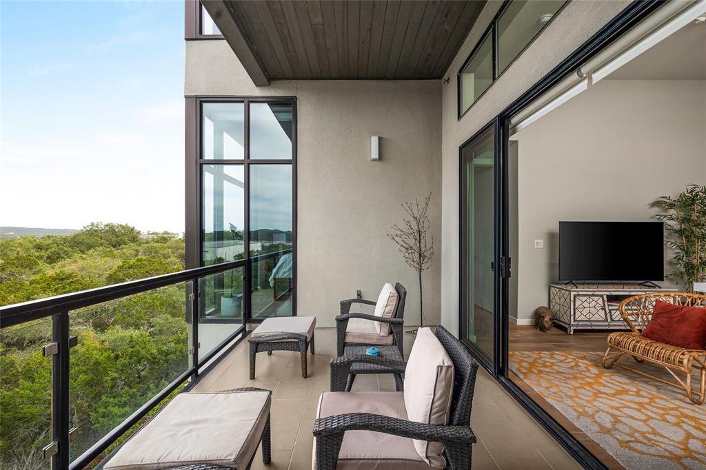 5921 Hiline Road, Unit 2404 Austin, TX 78734 - Photo 16 of 36 a living room with furniture and a flat screen tv