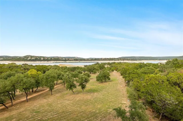 a bedroom with a bed and a flat screen tv on the dresser