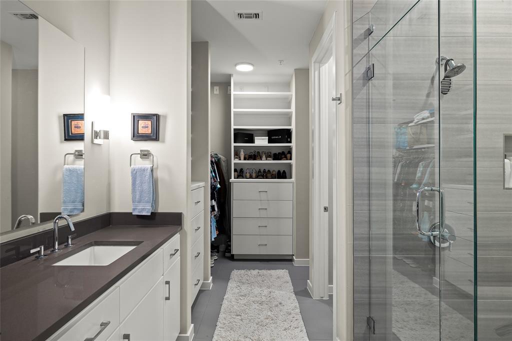 5921 Hiline Road, Unit 2404 Austin, TX 78734 - Photo 22 of 36 a bathroom with a granite countertop sink two mirror and shower