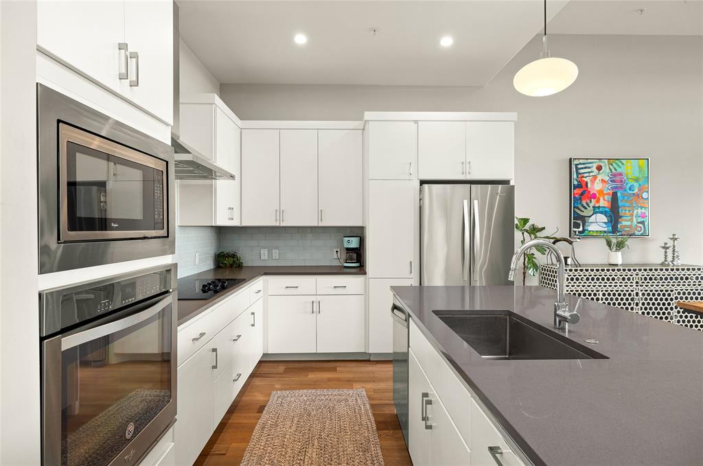 5921 Hiline Road, Unit 2404 Austin, TX 78734 - Photo 7 of 36 a kitchen with granite countertop a sink stove and refrigerator