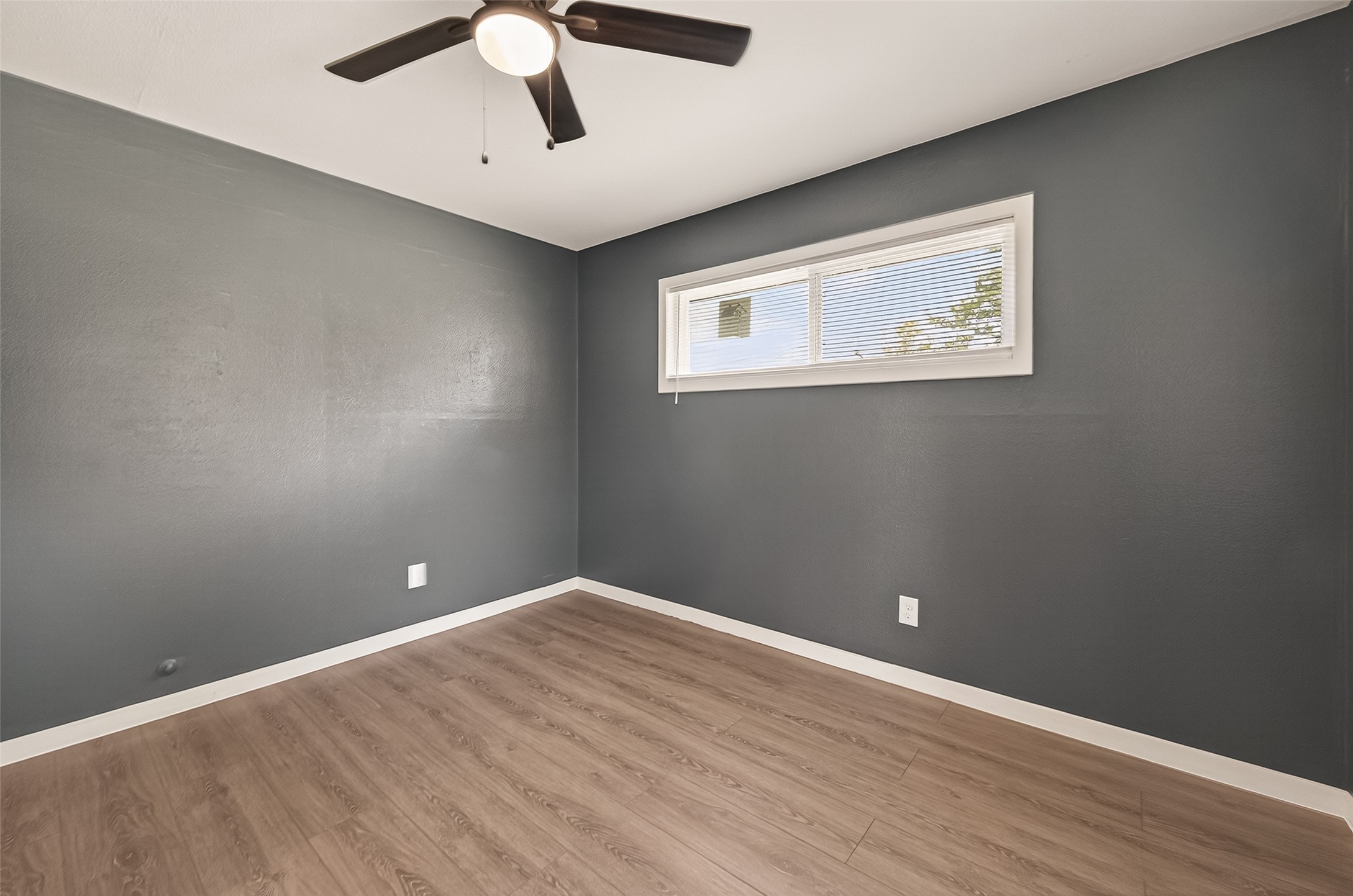 2619 Sinclair Street Pasadena, TX 77503 - Photo 15 of 29 an empty room with wooden floor and windows