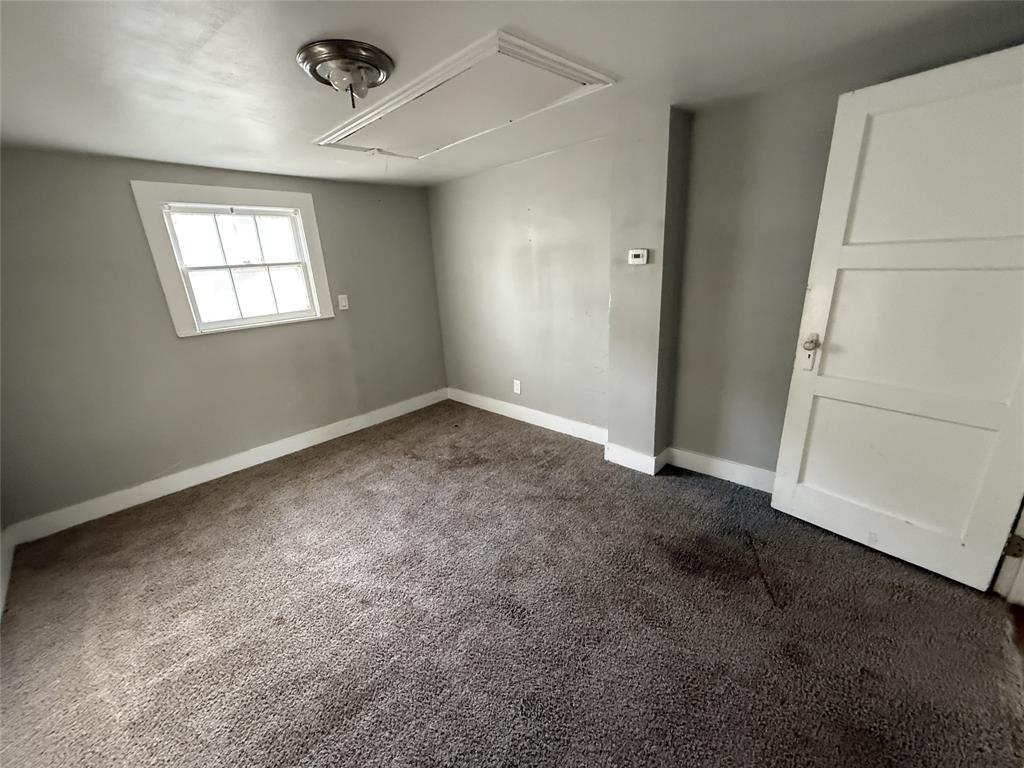 402 West 4th Street, Unit 1 Kaufman, TX 75142 - Photo 12 of 18 an empty room with windows