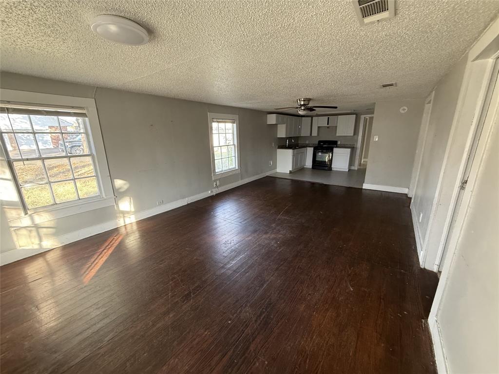 402 West 4th Street, Unit 1 Kaufman, TX 75142 - Photo 6 of 18 wooden floor in an empty room with a window