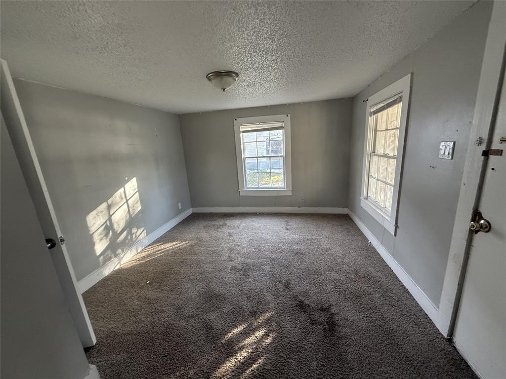 402 West 4th Street, Unit 1 Kaufman, TX 75142 - Photo 7 of 18 wooden floor in an empty room with a window