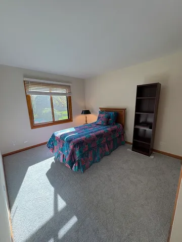 a bedroom with bed and a window