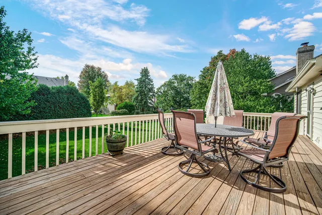 a view of a deck with chair and wooden floor
