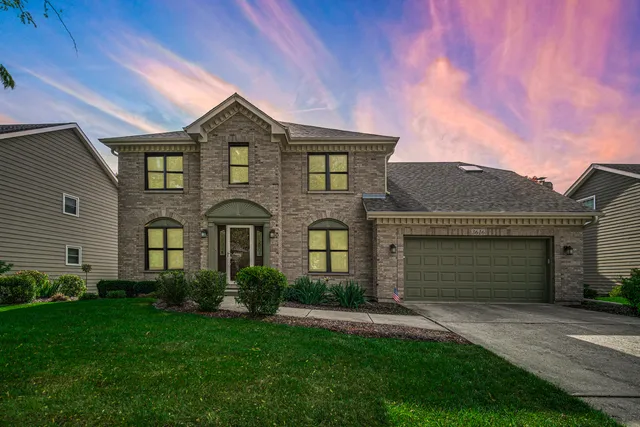 front view of brick house with a yard