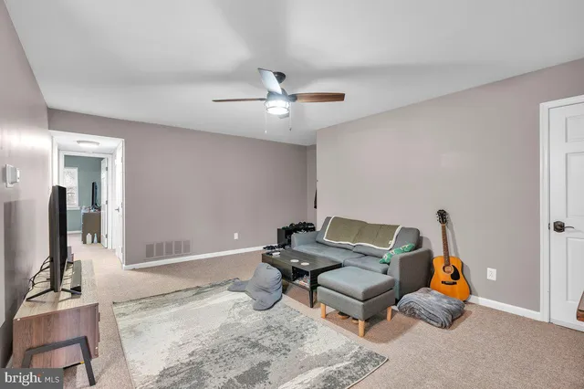 a living room with furniture gym equipment and a chandelier