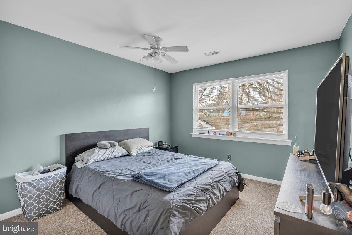702 Winding Way Westville, NJ 08093 - Photo 16 of 22 a bedroom with a bed and a flat tv screen on a dresser